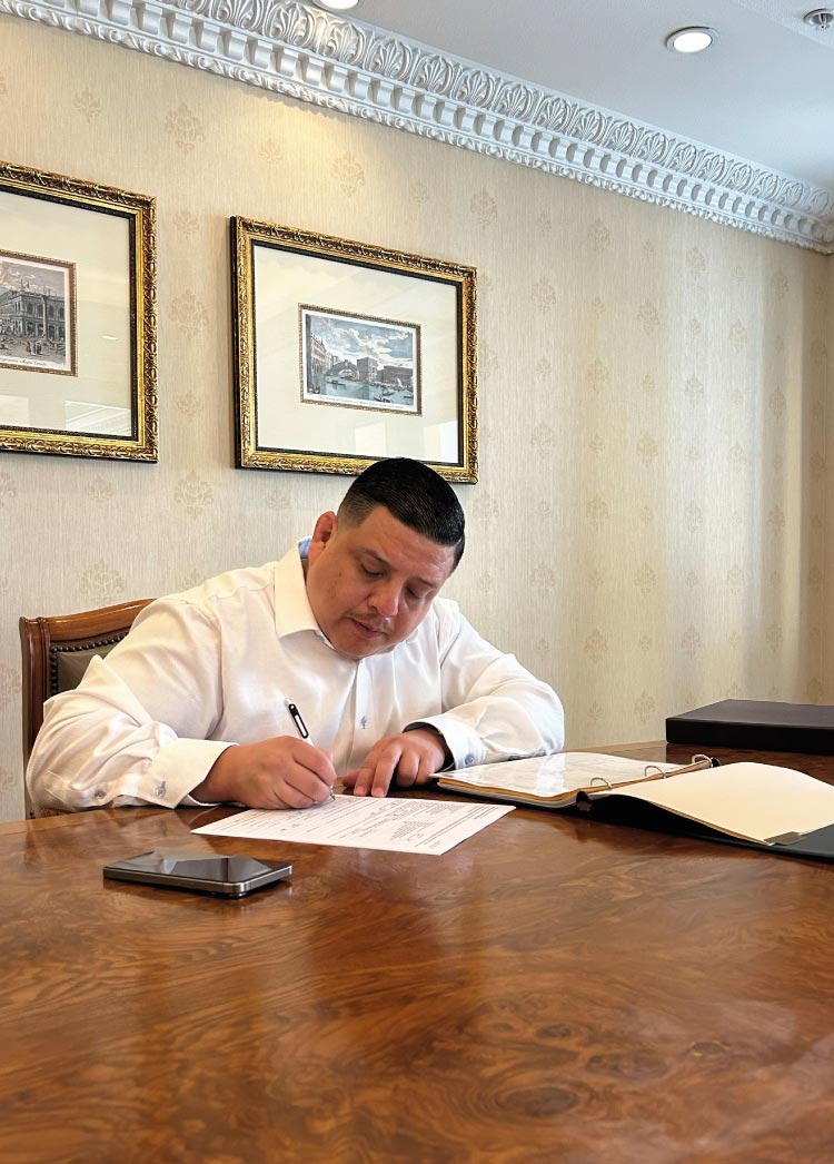 Experienced Los Angeles small business consultant Marcelo Umanzor Blanco reviewing legal filings and business formation documents for a new client.