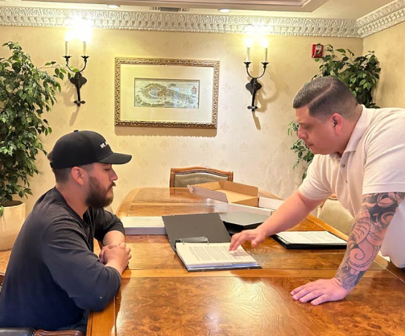 A professional business consultant reviewing strategic growth plans and financial documentation with an entrepreneur during a corporate consulting session.