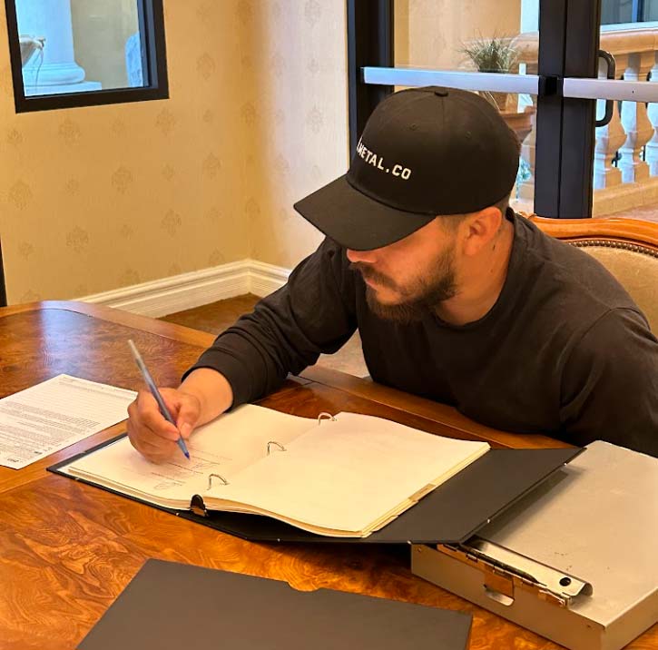 Entrepreneur filling out legal permit and business entity formation paperwork at Pro Business Solutions